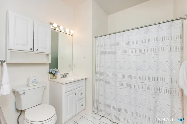 a bathroom with a toilet a sink and a shower