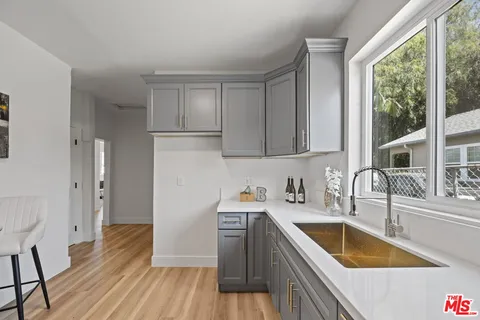 a kitchen with stainless steel appliances granite countertop a sink dishwasher stove and refrigerator