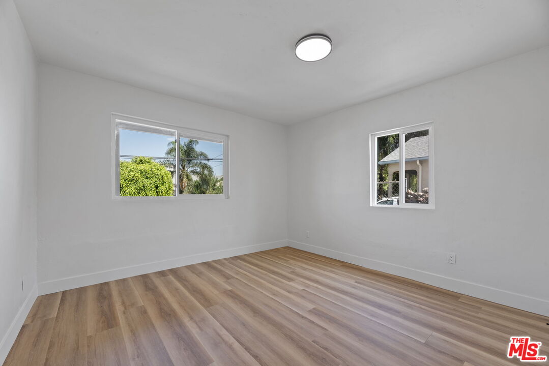 1450 Ricardo Street Los Angeles, CA 90033 - Photo 4 of 19 a view of an empty room with wooden floor and a window