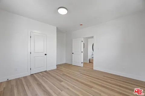 a view of an empty room and wooden floor