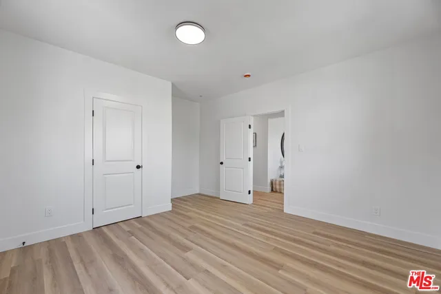 a view of an empty room and wooden floor