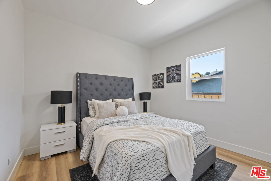 1450 Ricardo Street Los Angeles, CA 90033 - Photo 6 of 19 a bedroom with a bed and wooden floor