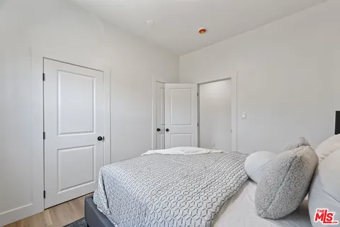 a bedroom with a bed and a chair