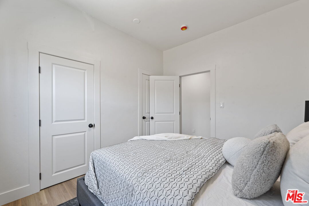 1450 Ricardo Street Los Angeles, CA 90033 - Photo 7 of 19 a bedroom with a bed and a chair