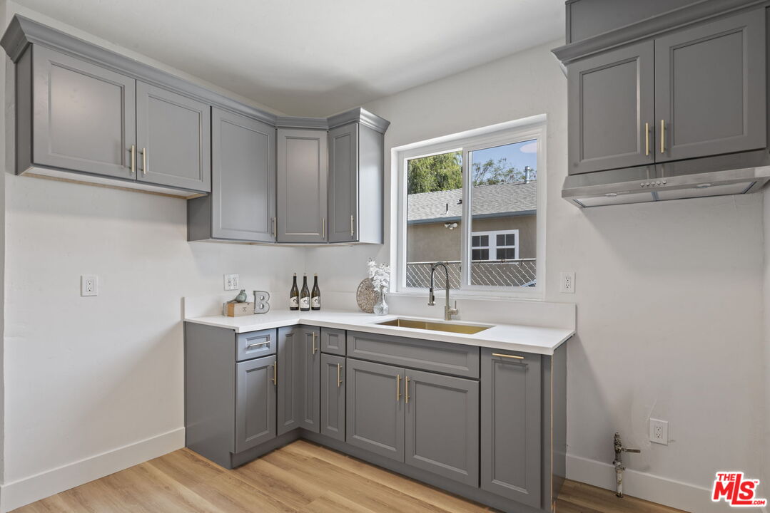 1450 Ricardo Street Los Angeles, CA 90033 - Photo 10 of 19 a kitchen with a sink cabinets and wooden floor