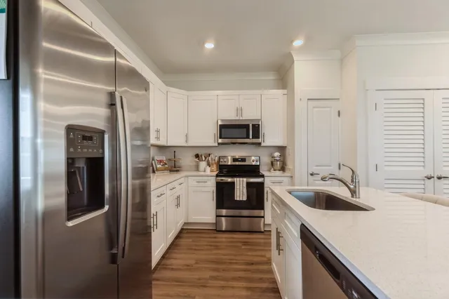 a kitchen with a sink cabinets and stainless steel appliances