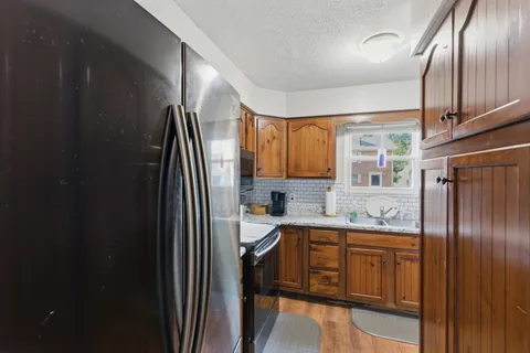 a kitchen with stainless steel appliances granite countertop a refrigerator sink and cabinets