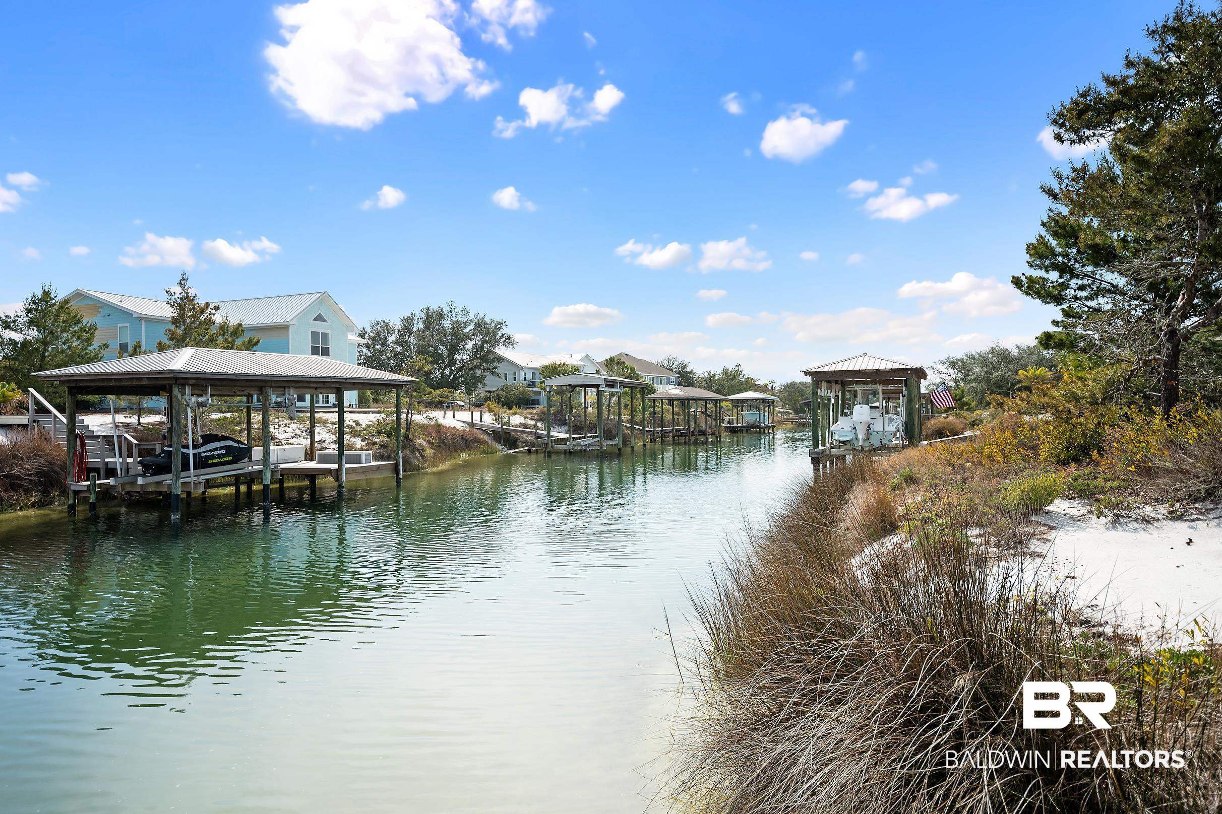 33186 Marlin Key Drive Orange Beach, AL 36561 - Photo 20 of 87 Dock area with boat lift, a water view, and a residential view