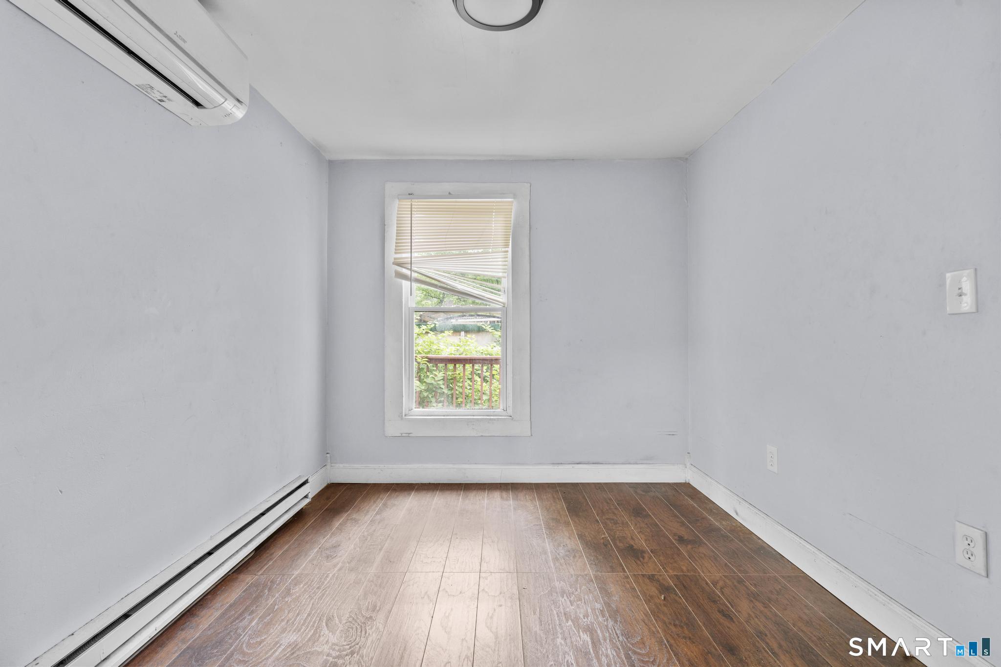 101 Meridian Street Meriden, CT 06451 - Photo 25 of 26 an empty room with wooden floor and windows