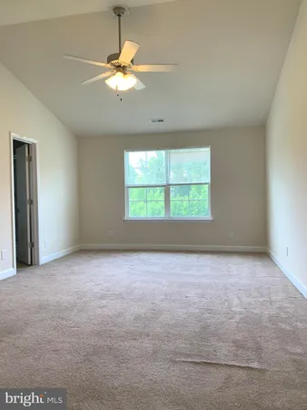 a view of a big room with an empty space and windows