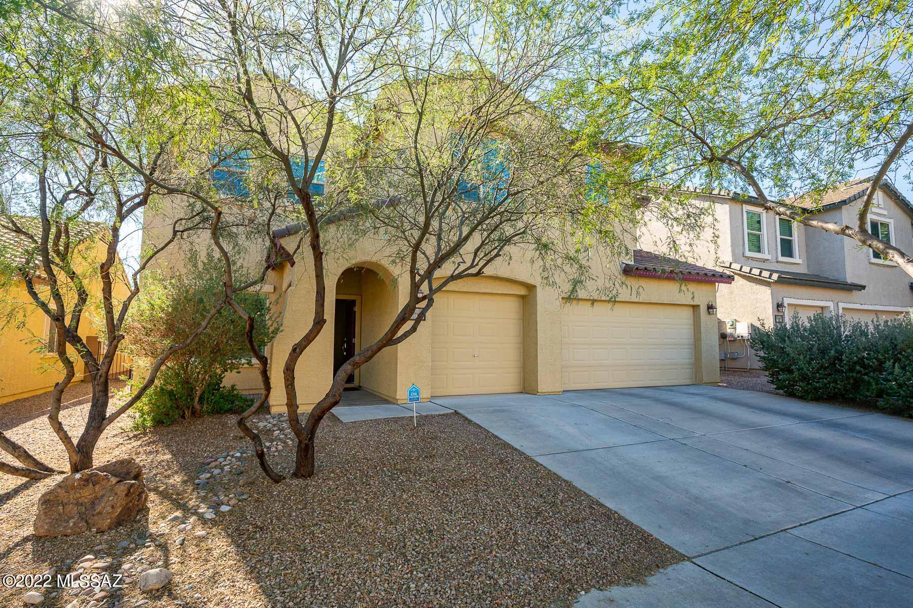 10804 East Salsabila Road Tucson, AZ 85747 - Photo 1 of 50 a view of a house with a yard and large tree