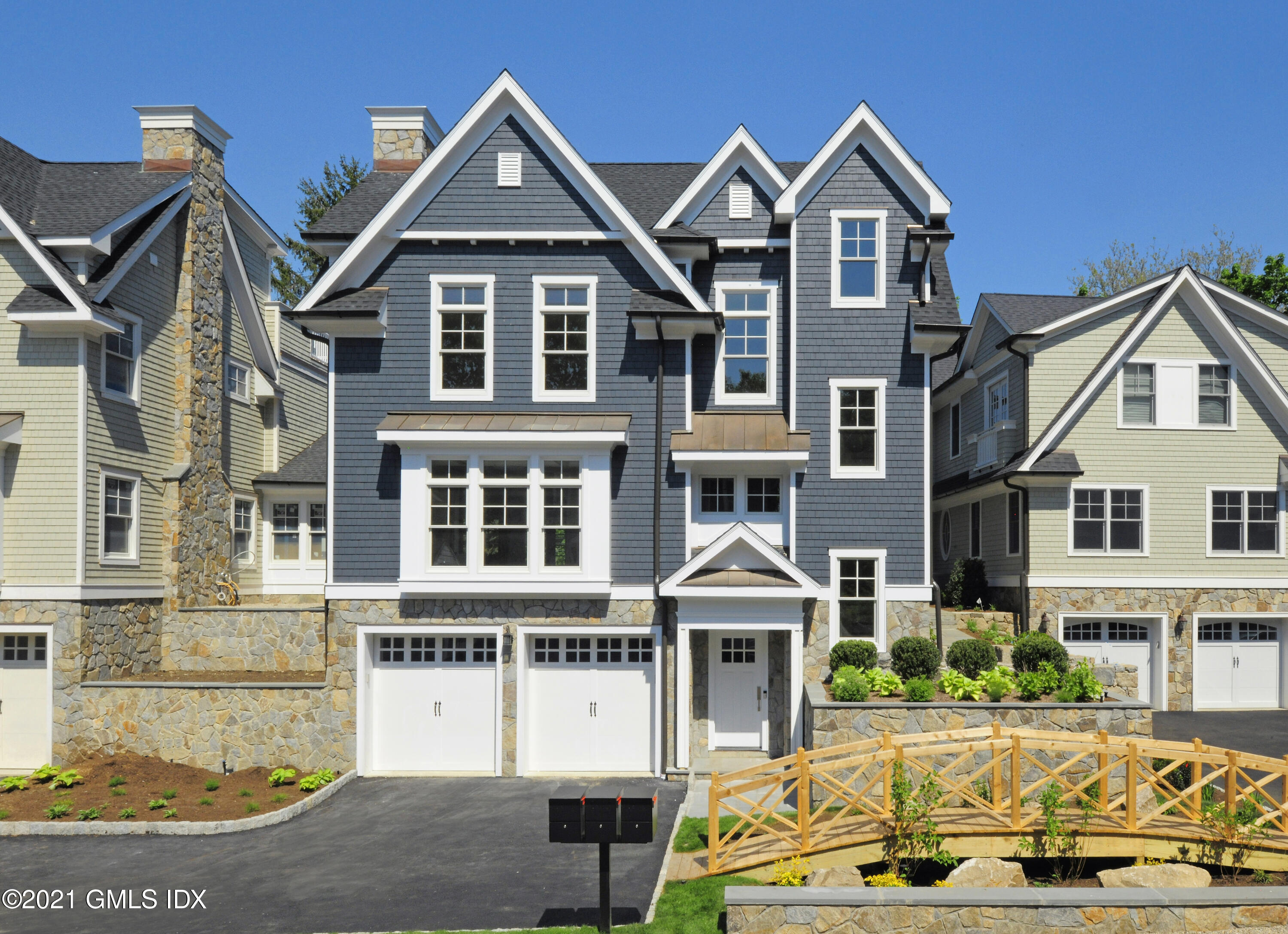 a front view of a residential apartment building with a yard