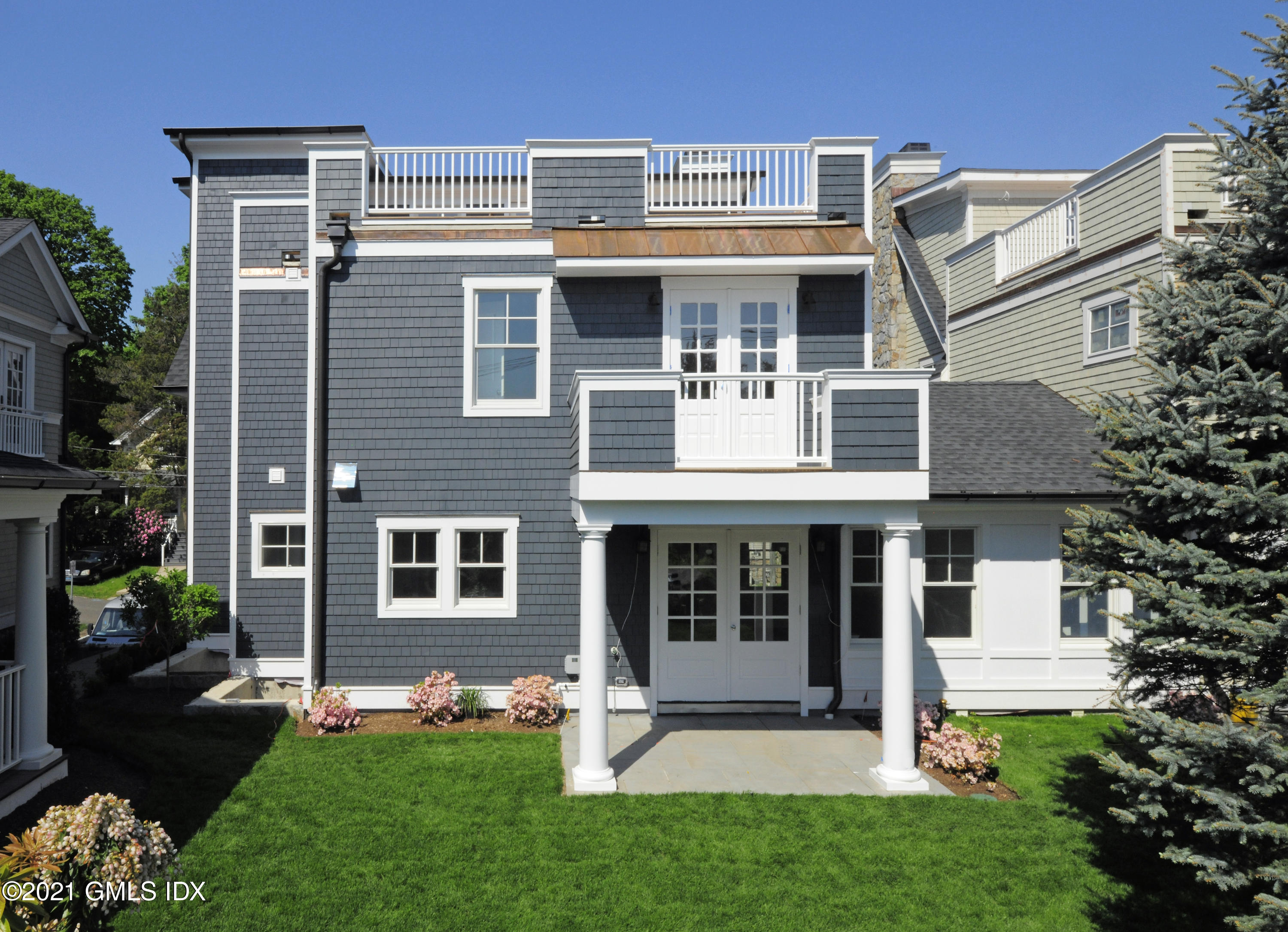 1 Home Place, Unit B Greenwich, CT 06830 - Photo 23 of 26 a front view of a house with a yard and garage