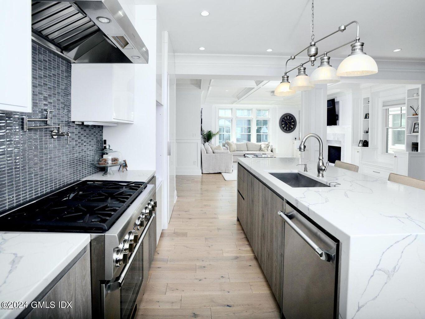 1 Home Place, Unit B Greenwich, CT 06830 - Photo 5 of 26 a kitchen with a sink stove and cabinets