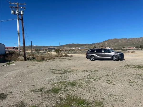 a view of a ocean view with a car parked in the background
