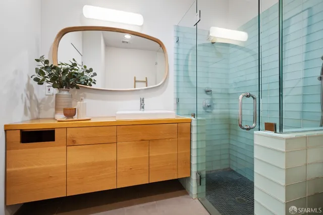 a bathroom with a sink a mirror and shower