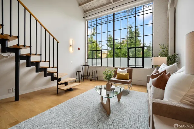 a living room with furniture and floor to ceiling windows