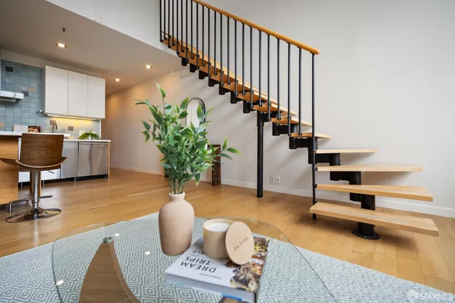 a living room with furniture and stairs