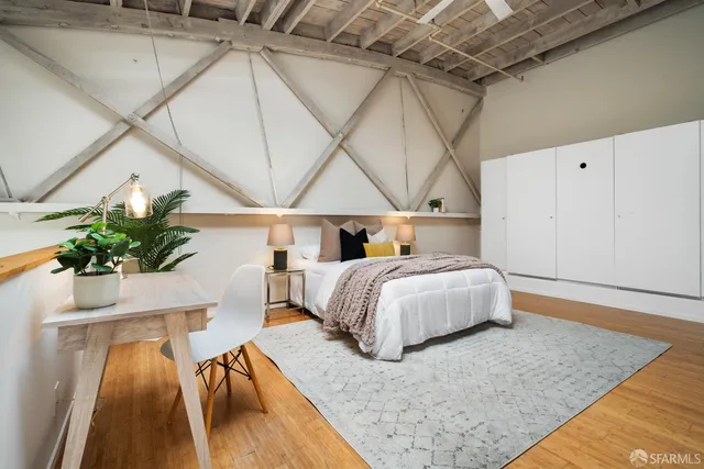 a bedroom with a bed and a potted plant