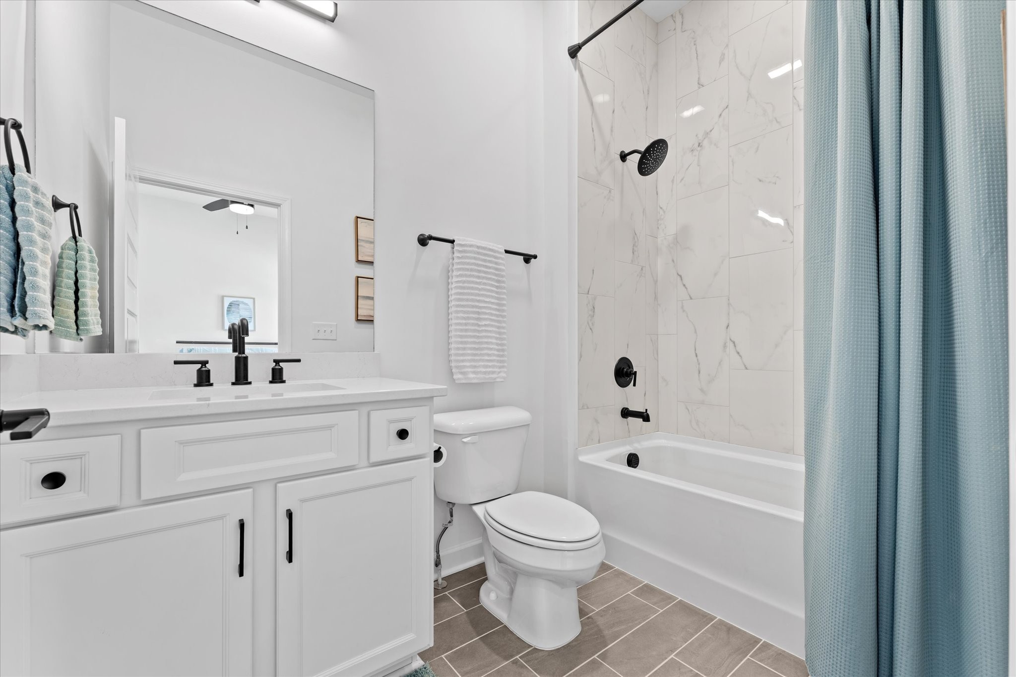 211 Folsom Pass, Unit B Spring Hill, TN 37174 - Photo 18 of 24 a bathroom with a sink a toilet a mirror a bathtub and shower