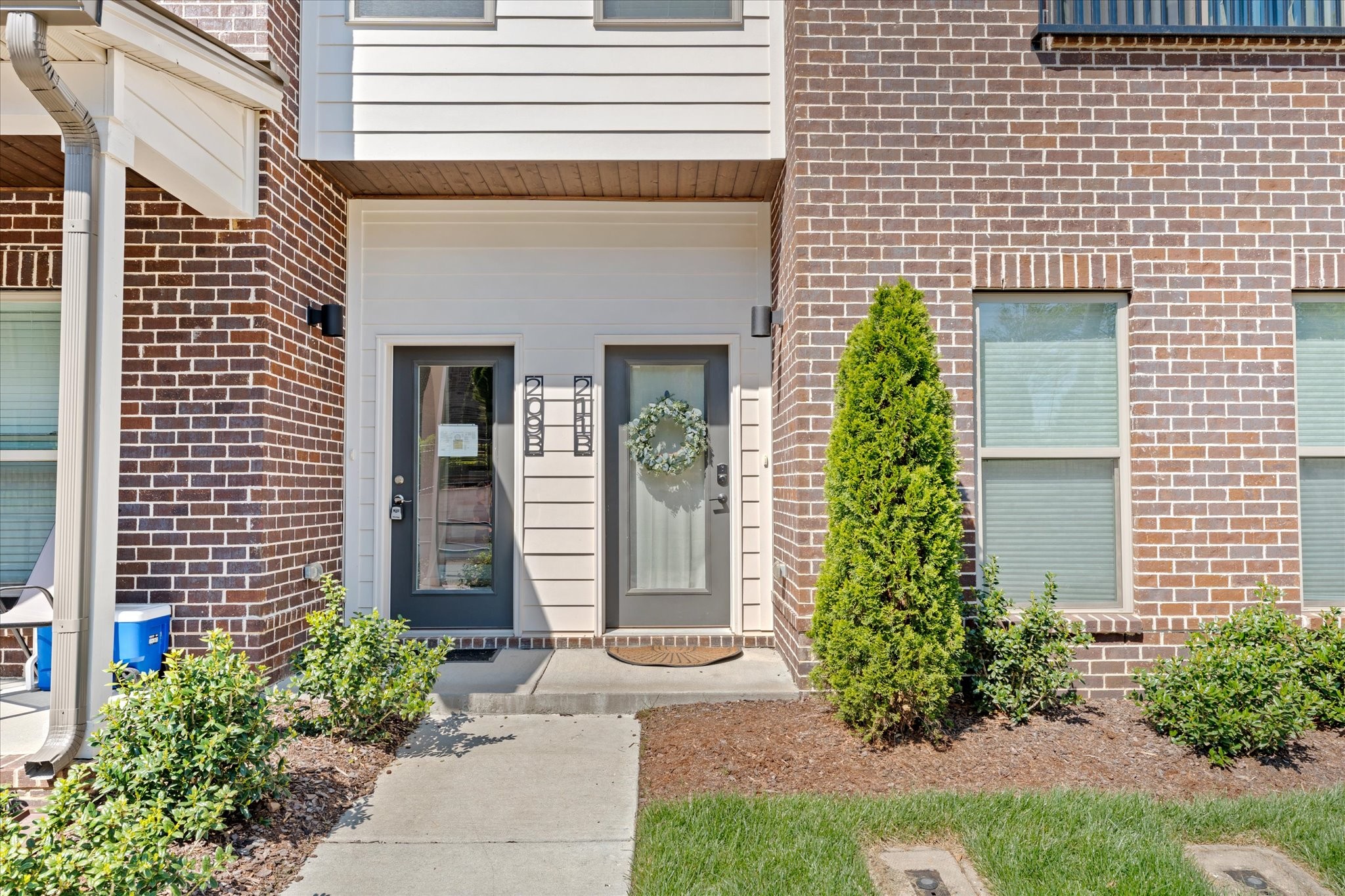 211 Folsom Pass, Unit B Spring Hill, TN 37174 - Photo 3 of 24 a front view of a house with garden