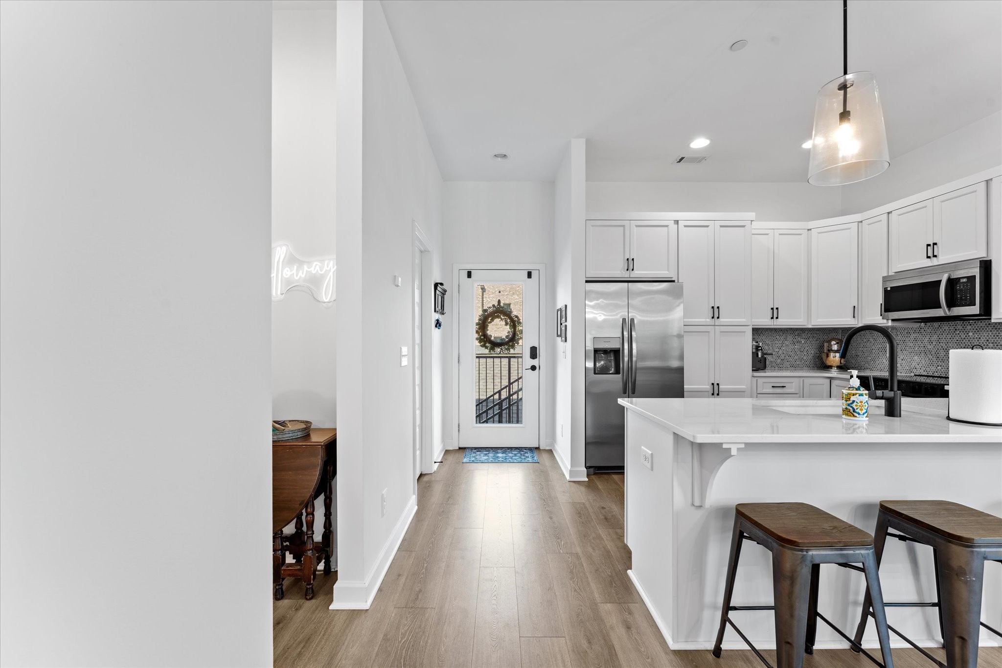 211 Folsom Pass, Unit B Spring Hill, TN 37174 - Photo 5 of 24 a kitchen with kitchen island wooden floors white appliances and cabinets