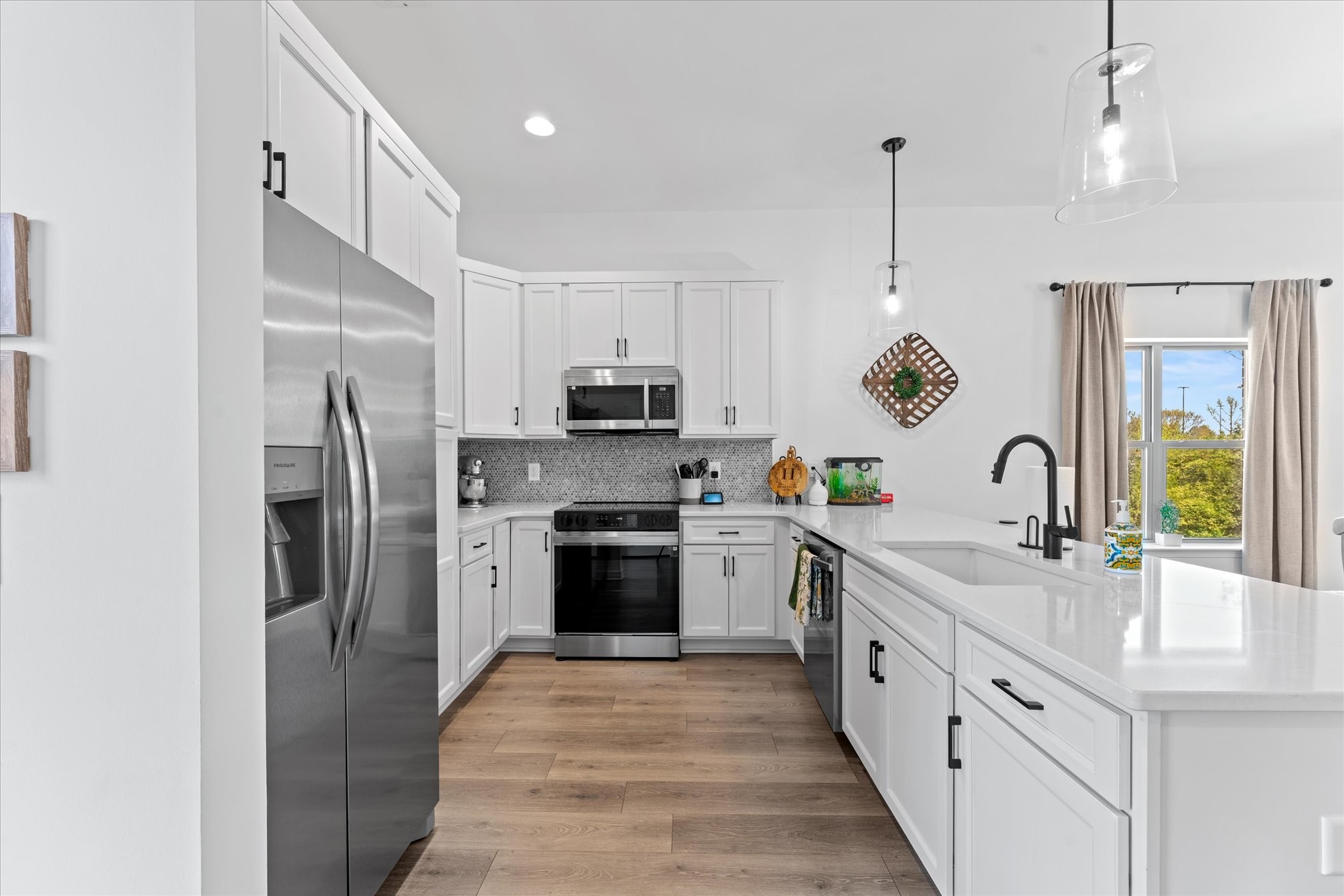 211 Folsom Pass, Unit B Spring Hill, TN 37174 - Photo 7 of 24 a large kitchen with stainless steel appliances granite countertop a sink a stove and a refrigerator