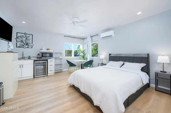 a large bedroom with a bed and a flat screen tv