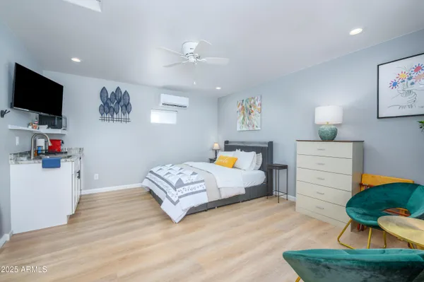 a bedroom with furniture and a flat screen tv