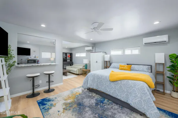 a bedroom with a bed and flat screen tv