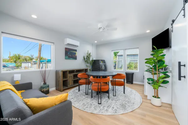 a living room with furniture potted plant and a window