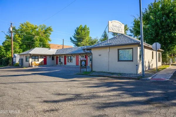a view of street along with house and trees