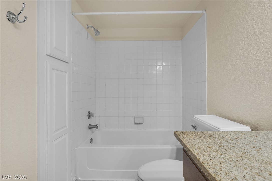 8101 West Flamingo Road, Unit 2001 Las Vegas, NV 89147 - Photo 10 of 28 Functional full bathroom featuring a tub and shower combination with clean tile surround.