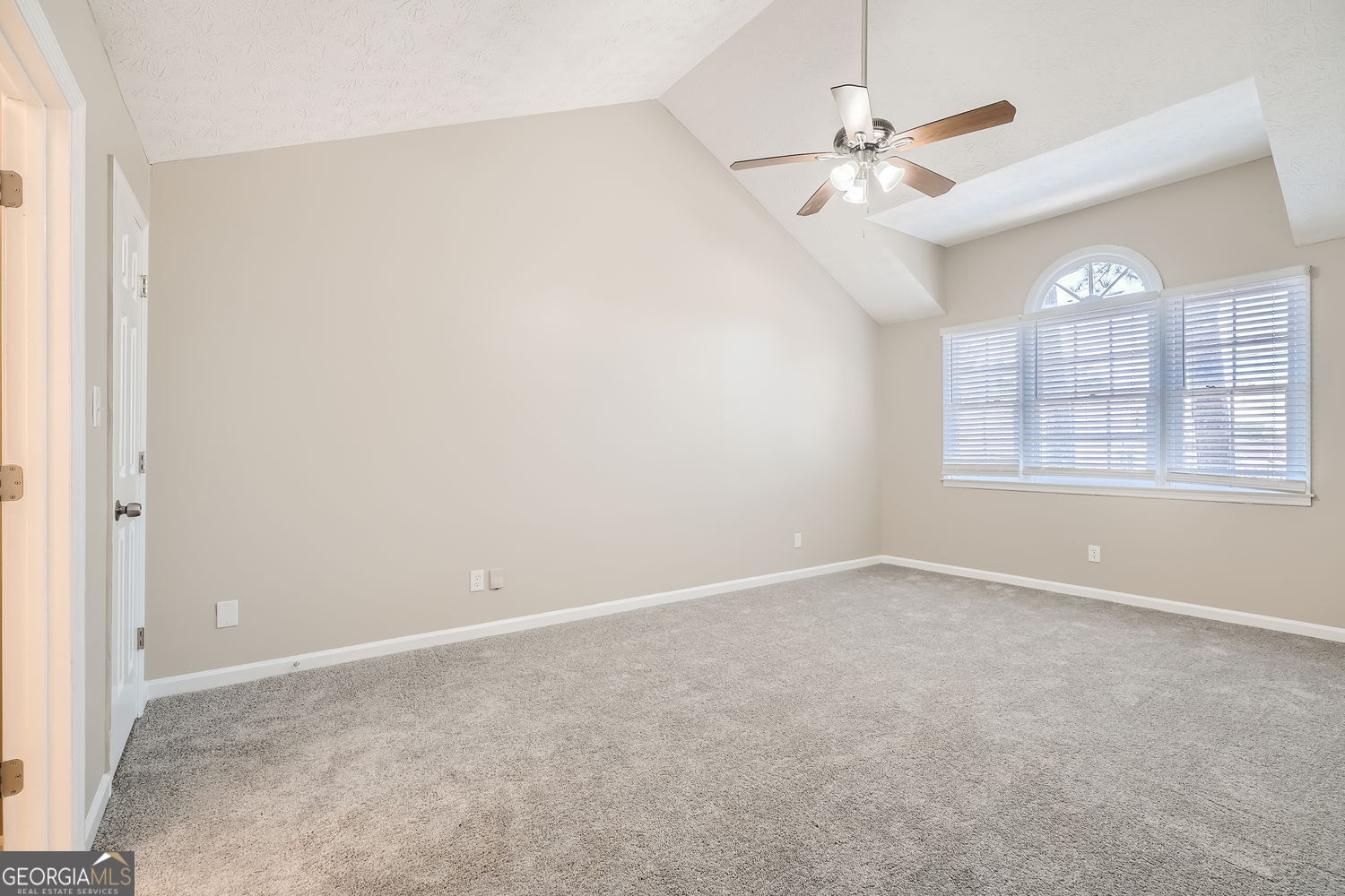 849 Ridge Avenue Stone Mountain, GA 30083 - Photo 6 of 11 an empty room with windows and fan
