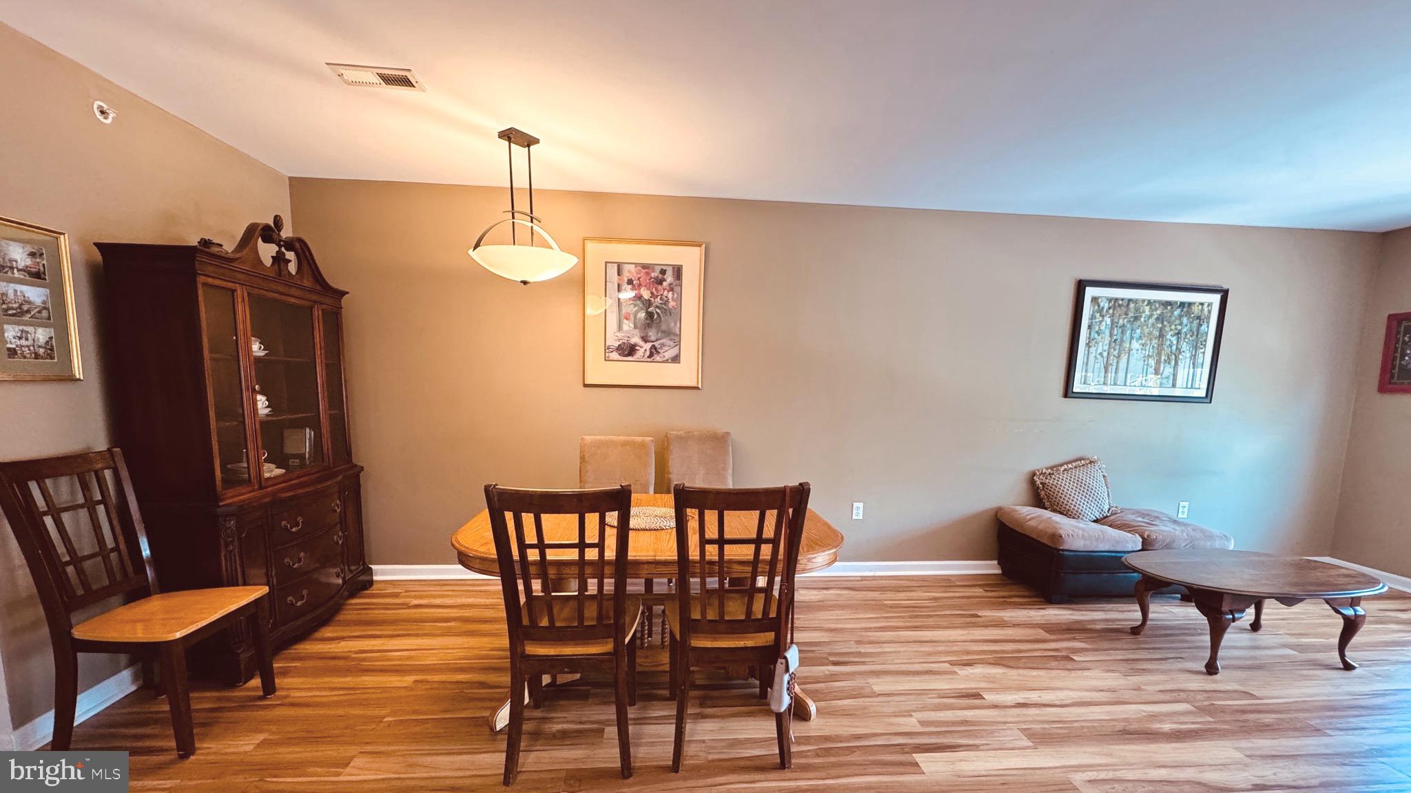 9228 Blue Grass Road, Unit 38 Philadelphia, PA 19114 - Photo 3 of 11 a living room with furniture and wooden floor