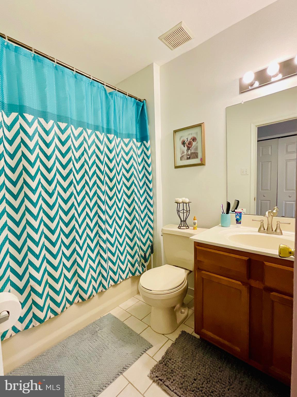 9228 Blue Grass Road, Unit 38 Philadelphia, PA 19114 - Photo 5 of 11 a bathroom with a sink toilet and a mirror