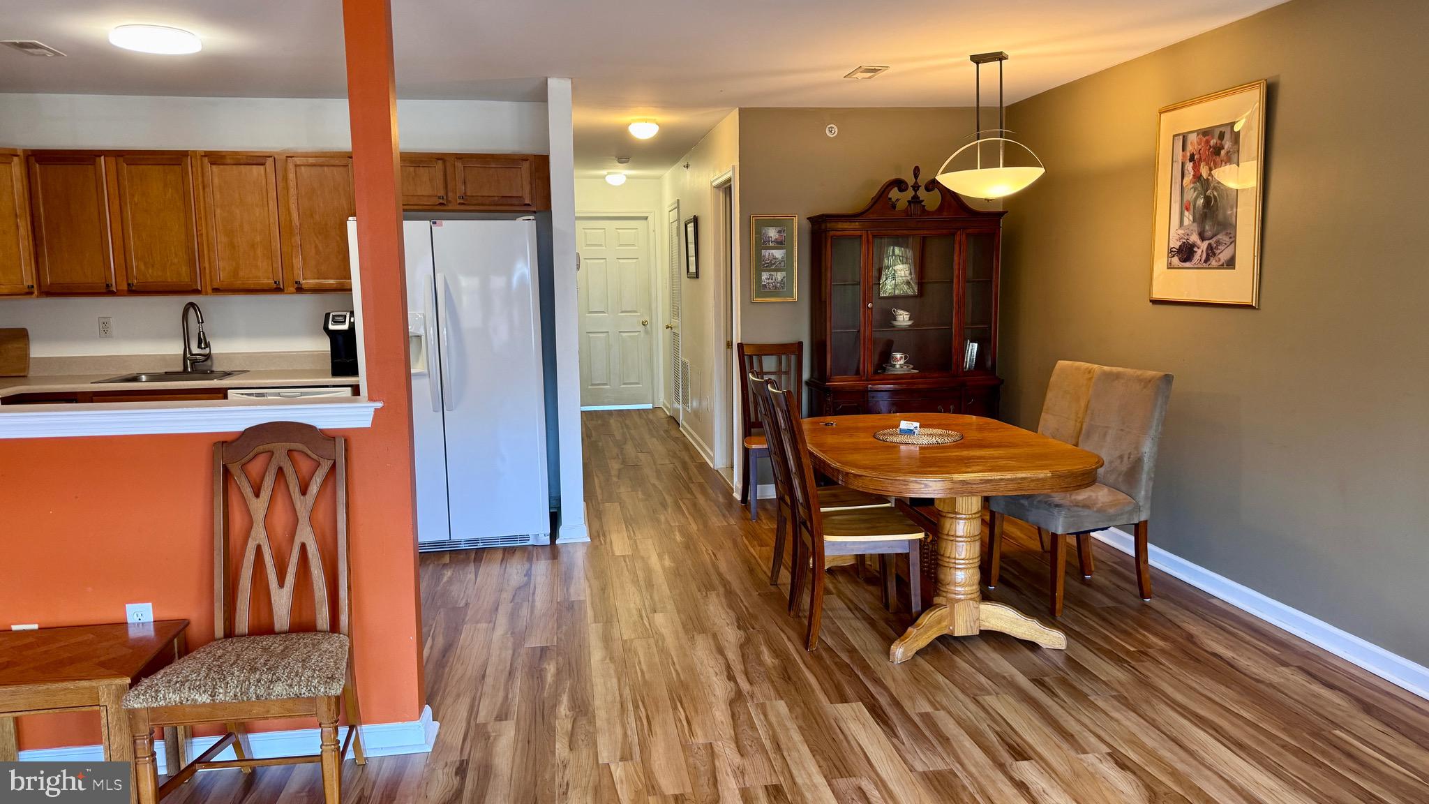 9228 Blue Grass Road, Unit 38 Philadelphia, PA 19114 - Photo 9 of 11 a view of a kitchen area with furniture and wooden floor