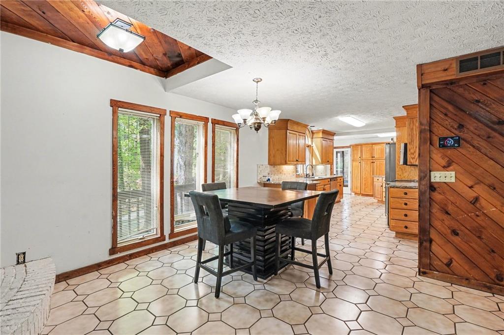 2530 Rockbridge Road Northwest Conyers, GA 30012 - Photo 13 of 45 a view of a dining room with furniture and chandelier