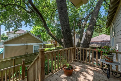 a view of a chair and table on the wooden deck