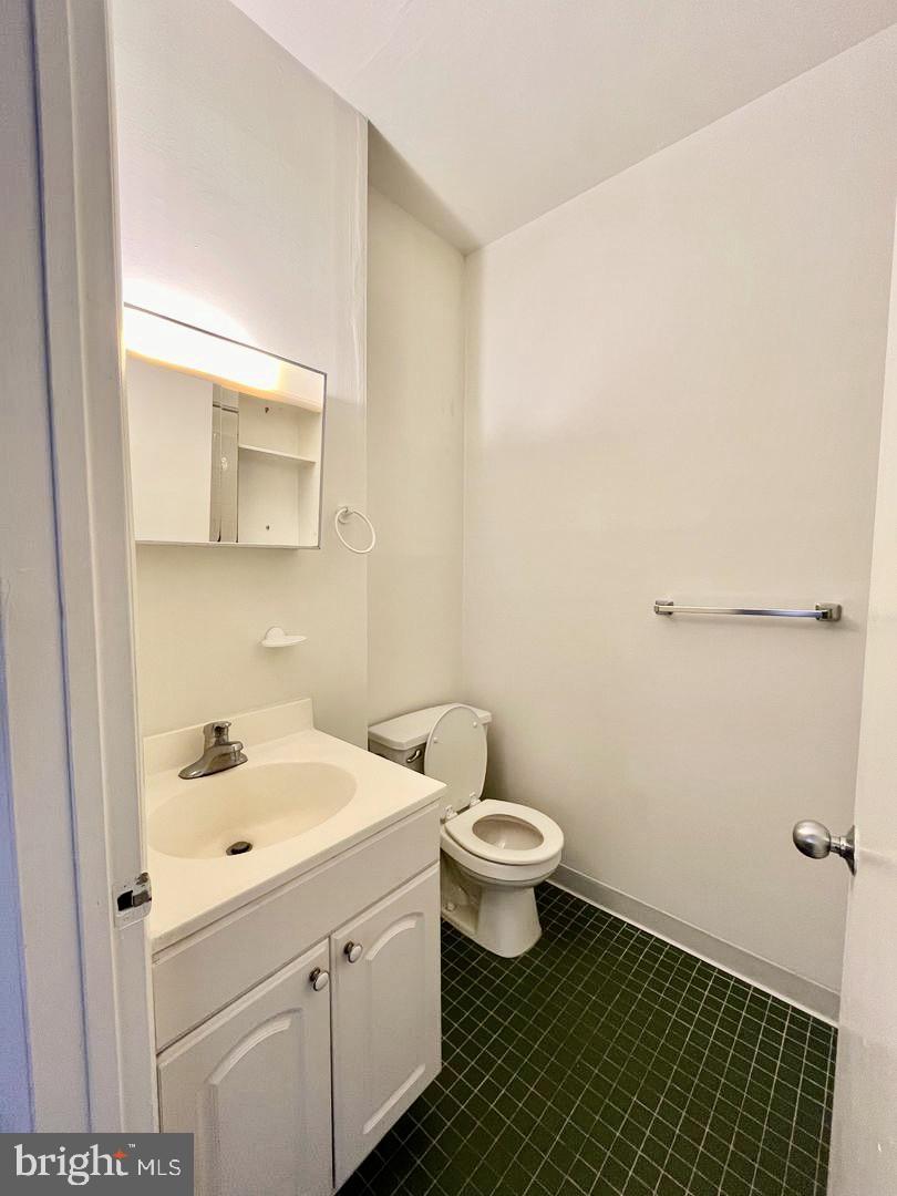 1203 Locust Street, Unit 1F Philadelphia, PA 19107 - Photo 11 of 15 a bathroom with a sink toilet and mirror