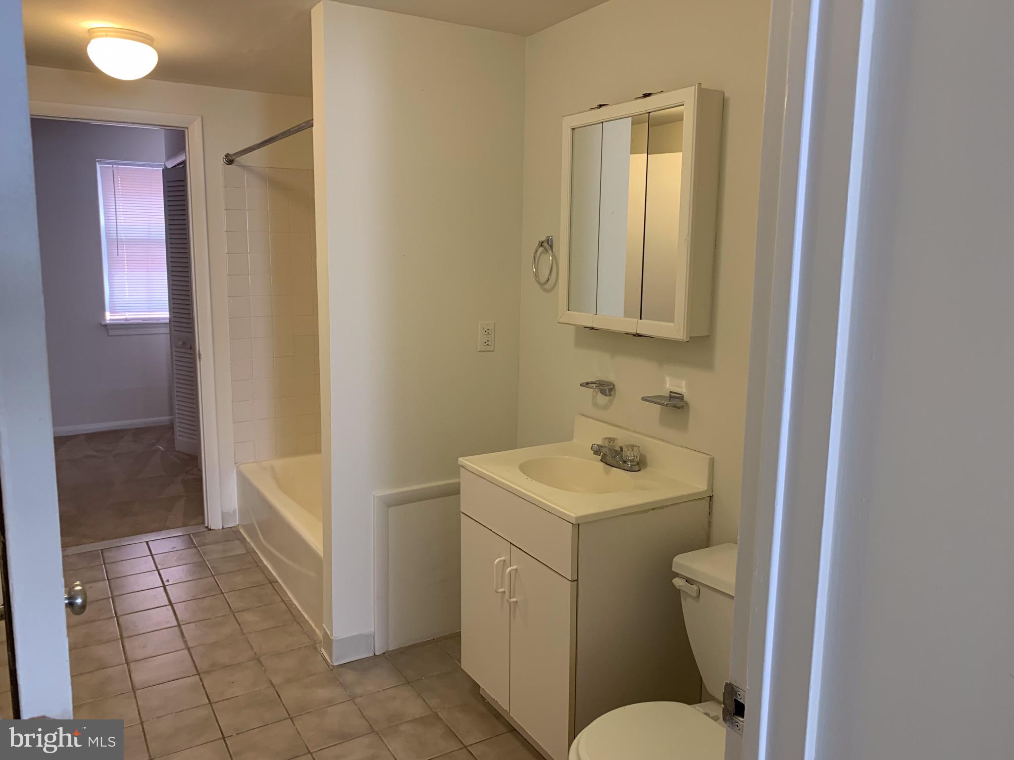 1203 Locust Street, Unit 1F Philadelphia, PA 19107 - Photo 7 of 15 a bathroom with a sink a toilet and shower