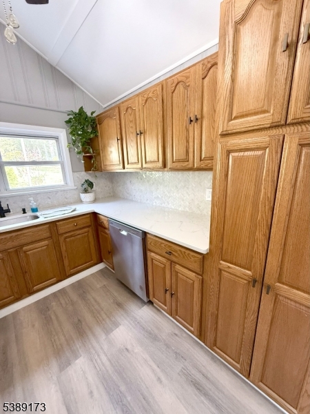 62 Wolfe Road, Unit 63 Budd Lake, NJ 07828 - Photo 13 of 19 a kitchen with stainless steel appliances granite countertop a refrigerator a sink dishwasher and wooden cabinets with wooden floor