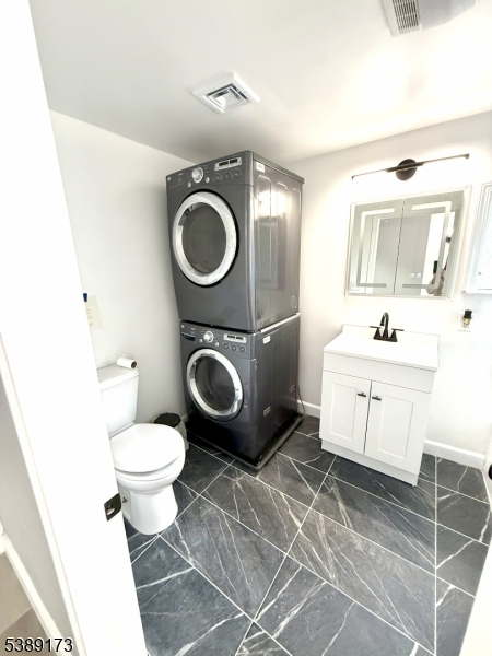 62 Wolfe Road, Unit 63 Budd Lake, NJ 07828 - Photo 9 of 19 a bathroom with a toilet a sink and a mirror