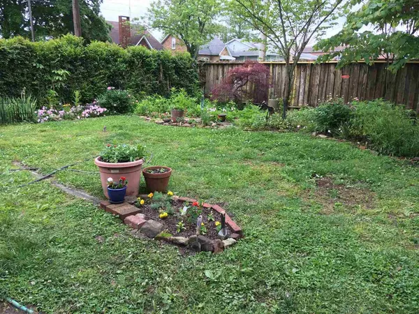 a view of a chair and table in the back yard