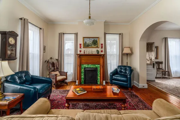 a living room with furniture fireplace and window