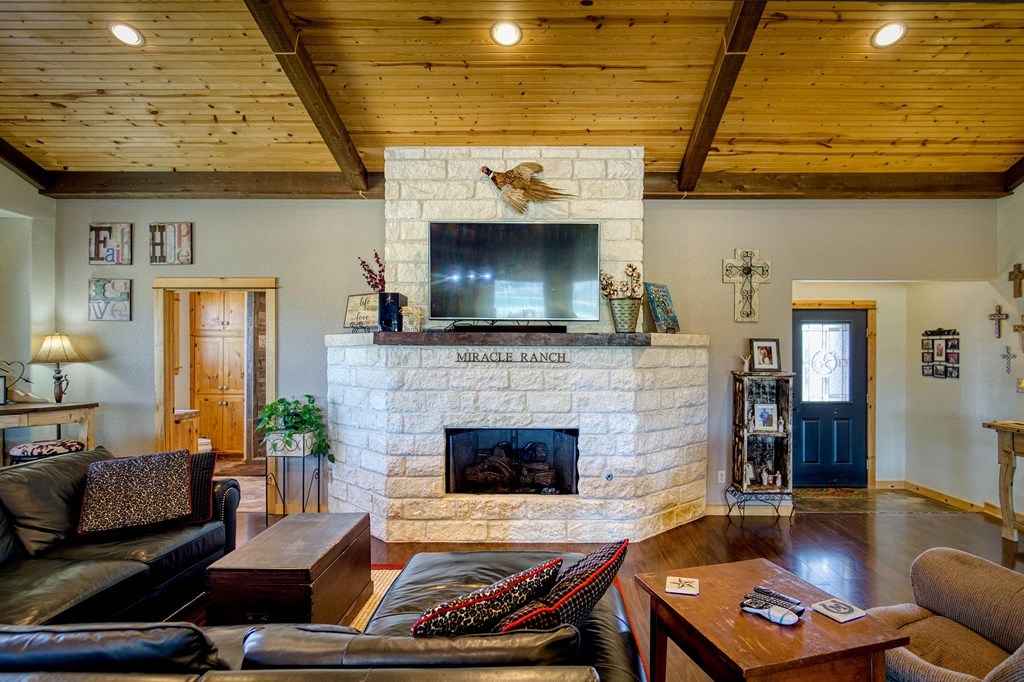 6446 Blackjack Road Fredonia, TX 76842 - Photo 10 of 48 a living room with furniture and a fireplace