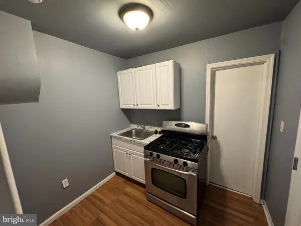 a kitchen with a stove and a refrigerator