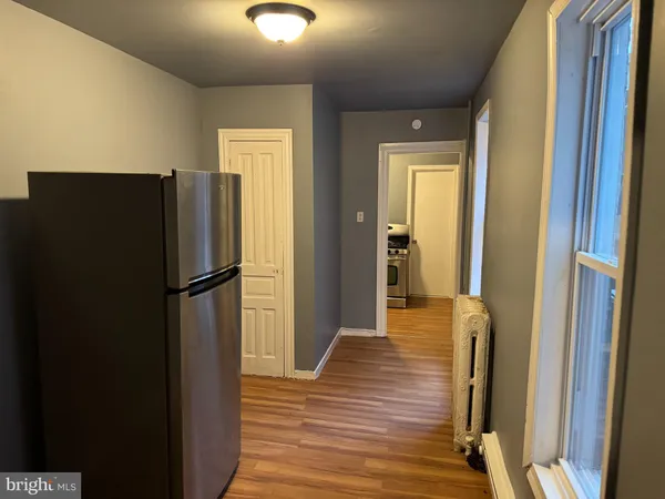 a view of a refrigerator in kitchen and wooden floor