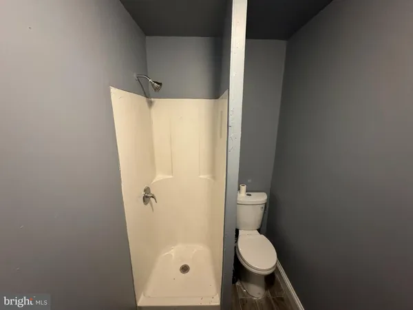 a bathroom with a granite countertop toilet and a sink