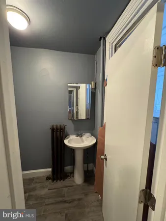 a bathroom with a sink toilet and mirror